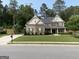 Attractive exterior view of the home showcasing its well-kept lawn and traditional architectural style at 6660 Canyon Cv, Cumming, GA 30028