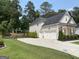 View of the driveway and garage, highlighting the home's ample parking and storage space at 6660 Canyon Cv, Cumming, GA 30028