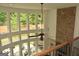 Bright great room showcasing the floor-to-ceiling brick fireplace and large windows at 6660 Canyon Cv, Cumming, GA 30028