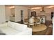 Open concept kitchen and living area with stainless steel appliances and pendant lighting at 6660 Canyon Cv, Cumming, GA 30028
