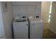 Bright laundry area features modern white washer and dryer units at 6660 Canyon Cv, Cumming, GA 30028