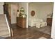 Cozy living room featuring hardwood floors, a staircase, and a comfortable sofa at 6660 Canyon Cv, Cumming, GA 30028
