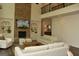 Spacious living room with a brick fireplace, built-ins, and a soaring two-story ceiling at 6660 Canyon Cv, Cumming, GA 30028