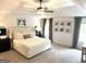 Spacious main bedroom featuring neutral decor, a ceiling fan, and large windows at 6660 Canyon Cv, Cumming, GA 30028