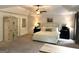 Spacious main bedroom featuring neutral decor and an armoire for extra storage at 6660 Canyon Cv, Cumming, GA 30028
