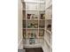 Well-organized walk-in pantry with ample shelving for storage and organization at 6660 Canyon Cv, Cumming, GA 30028