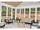 Inviting sunroom with cozy seating, large windows, and peaceful outdoor views at 6660 Canyon Cv, Cumming, GA 30028