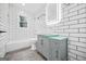 Elegant bathroom with subway tile, modern vanity, and well-lit mirror at 1 Lamar Ave Sw, Atlanta, GA 30310