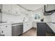 Modern kitchen with white cabinets, quartz countertops, and stainless steel appliances at 1 Lamar Ave Sw, Atlanta, GA 30310