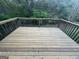 A wooden back deck with green foliage in the background at 194 Bay Court Dr, Stockbridge, GA 30281