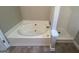 A bathroom featuring a relaxing garden tub and a separate shower at 194 Bay Court Dr, Stockbridge, GA 30281