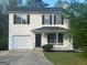 Two-story home with attached garage, black shutters, and landscaped yard at 194 Bay Court Dr, Stockbridge, GA 30281