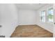 Bright, spacious bedroom with wood-look flooring and a double window, ready for customization and relaxation at 1184 Bluecoat Cir # 84, Hampton, GA 30228