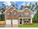 Beautiful two-story brick home featuring a welcoming entrance, manicured lawn, and two-car garage, perfect for Gathering living at 1184 Bluecoat Cir # 84, Hampton, GA 30228
