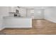 Open-concept kitchen features granite countertops, modern appliances, and wood-look floors, creating an inviting space for cooking at 1184 Bluecoat Cir # 84, Hampton, GA 30228