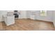 Bright, modern kitchen featuring granite counters, stainless steel appliances, and wood-look flooring at 1184 Bluecoat Cir # 84, Hampton, GA 30228