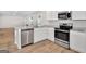 Modern kitchen featuring stainless steel appliances, granite counters, and wood-look flooring, perfect for Gathering gatherings at 1184 Bluecoat Cir # 84, Hampton, GA 30228