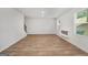 Spacious living room with wood-look flooring, fireplace, and natural light, perfect for Gathering gatherings and cozy evenings at 1184 Bluecoat Cir # 84, Hampton, GA 30228