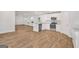 Spacious living room adjacent to the modern kitchen, featuring wood-look floors and ample natural light, perfect for entertaining at 1184 Bluecoat Cir # 84, Hampton, GA 30228