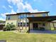 Spacious backyard features a covered patio, green lawn, and mature trees for shade and privacy at 206 Birchin Dr, Woodstock, GA 30188
