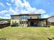 Expansive backyard with a covered patio and ample green space for outdoor activities at 206 Birchin Dr, Woodstock, GA 30188