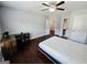 Bedroom with hardwood floors, fan, desk, and doorway to bath at 206 Birchin Dr, Woodstock, GA 30188
