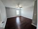 This bedroom features hardwood floors, neutral paint, and a ceiling fan at 206 Birchin Dr, Woodstock, GA 30188