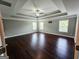 Spacious primary bedroom features tray ceilings, fan, and three large windows providing natural light at 206 Birchin Dr, Woodstock, GA 30188