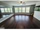 Large bonus room features dark wood floors and several windows providing natural light at 206 Birchin Dr, Woodstock, GA 30188