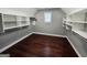 Walk-in closet with custom shelving and storage, hardwood floor, and a window at 206 Birchin Dr, Woodstock, GA 30188