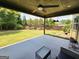 Relaxing covered patio with ceiling fan, string lights, and outdoor seating area overlooking backyard at 206 Birchin Dr, Woodstock, GA 30188