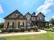 Charming two-story brick home with well-manicured landscaping and inviting front porch at 206 Birchin Dr, Woodstock, GA 30188