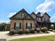 Beautiful two-story home boasting a brick facade, shutters, and lush landscaping at 206 Birchin Dr, Woodstock, GA 30188