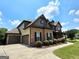 Lovely two-story brick home with a three-car garage and beautifully landscaped front yard at 206 Birchin Dr, Woodstock, GA 30188