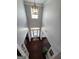 The foyer boasts soaring ceilings, a decorative chandelier, and dark hardwood flooring throughout at 206 Birchin Dr, Woodstock, GA 30188