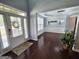 Inviting foyer with hardwood floors, a modern light fixture, and views into a naturally lit seating area at 206 Birchin Dr, Woodstock, GA 30188