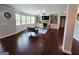 Spacious living room with hardwood floors, built-in shelving, fireplace, and large windows for ample lighting at 206 Birchin Dr, Woodstock, GA 30188
