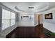 A naturally lit living room showcases the hardwood floors and traditional wainscoting details at 206 Birchin Dr, Woodstock, GA 30188