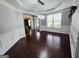 Bright living room featuring hardwood floors, modern lighting, and traditional wainscoting details at 206 Birchin Dr, Woodstock, GA 30188