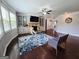 Cozy living room with hardwood floors, built-in shelving, a fireplace, and a blue patterned rug at 206 Birchin Dr, Woodstock, GA 30188
