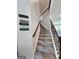 Carpeted staircase with wooden banister and a view into another room at 206 Birchin Dr, Woodstock, GA 30188