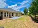 Large backyard with a patio area, manicured lawn, and planting station at 121 Pinnacle Ln, Mcdonough, GA 30253