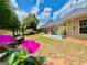 Landscaped backyard featuring patio, lawn, and a planting station, with flowers at 121 Pinnacle Ln, Mcdonough, GA 30253