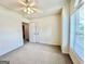 Bright bedroom with ceiling fan, white walls, and a large window with blinds at 121 Pinnacle Ln, Mcdonough, GA 30253