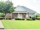 Brick building featuring covered front porch, mature trees, and manicured landscaping at 121 Pinnacle Ln, Mcdonough, GA 30253