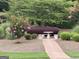 Serene garden area featuring a stone table with benches and colorful landscaping at 121 Pinnacle Ln, Mcdonough, GA 30253