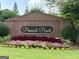 Pinnacle Pointe community sign surrounded by colorful flower beds and lush greenery at 121 Pinnacle Ln, Mcdonough, GA 30253