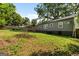Lush backyard featuring a deck, exterior of the home, and mature trees at 1675 Brewer Sw Blvd, Atlanta, GA 30310