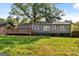 Expansive backyard highlighting the home's siding, windows, and a wooden deck at 1675 Brewer Sw Blvd, Atlanta, GA 30310