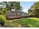 Green backyard with a wooden deck showcasing a tranquil outdoor living space at 1675 Brewer Sw Blvd, Atlanta, GA 30310